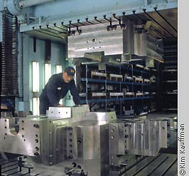 Industrial photograph of spotting press with workman by corporate photographer kim kauffman for a corporate brochure