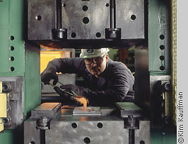 Industrial photograph of titanium forging of hip prothesis by industrial photographer kim kauffman for use in corporate brochure