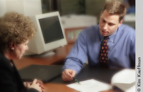 image of executives at work for annual report by lansing, mi photographer kim kauffman